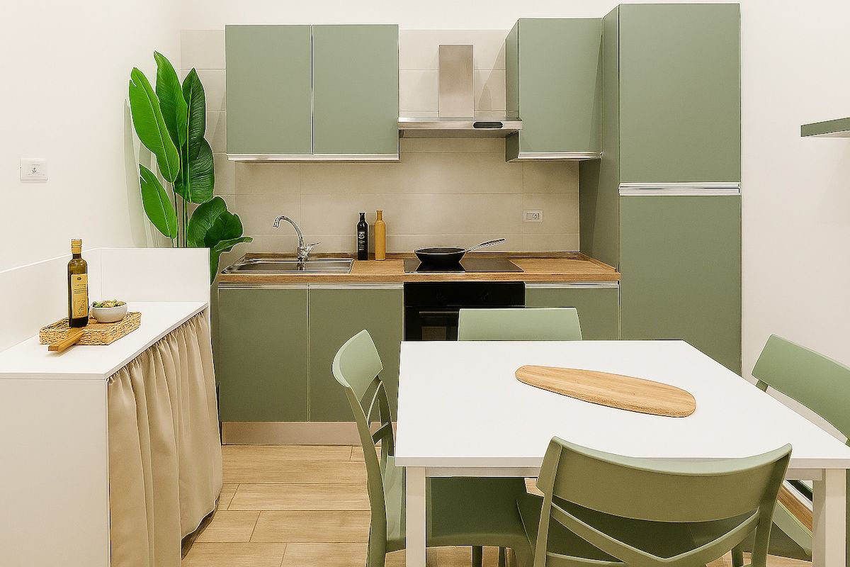 Sage-green kitchen with dining table for two